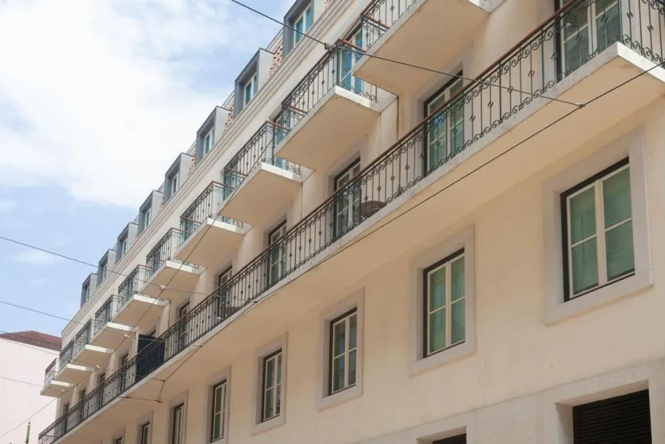 Classic façade with wrought-iron balconies on Rua dos Duques de Bragança, Lisbon